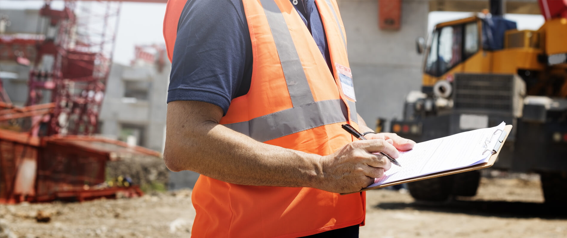 Man holding clipboard writing something with a pen